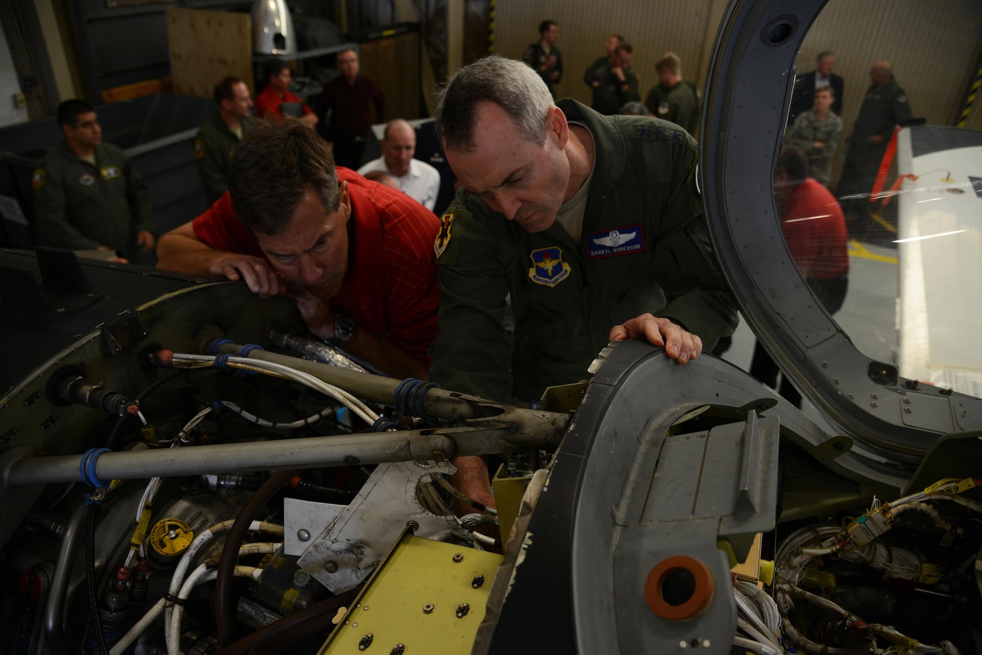 Lt. Gen. Darryl Roberson, commander of Air Education and Training Command, examines the internal structure of a T-6A Texan II aircraft with Russ Bartlett, defense contractor, on Laughlin Air Force Base, Texas, Nov. 16, 2015. The T-6 is a single-engine, two-seat, primary trainer designed to train student pilots on basic flying skills. (U.S. Air Force photo by Airman 1st Class Ariel D. Partlow)