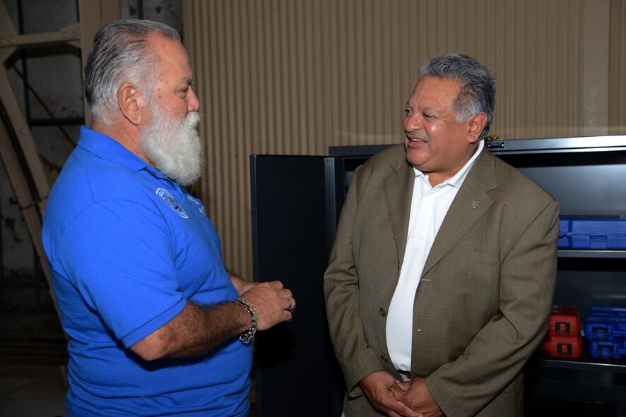 Gilbert Montoya, right, Air Education and Training Command director of logistics and force protection, discusses the “Grow Your Own” Program with Ruben Resendez, Del Rio High School Aircraft Technology instructor, on Laughlin Air Force Base, Texas, Nov. 16, 2015. The “Grow Your Own” Program is an aviation technology program that gives Del Rio High School students hands-on experience with aircraft servicing and maintenance training with the goal of preparing students for an aircraft maintenance career at Laughlin. (U.S. Air Force photo by Airman 1st Class Ariel D. Partlow)