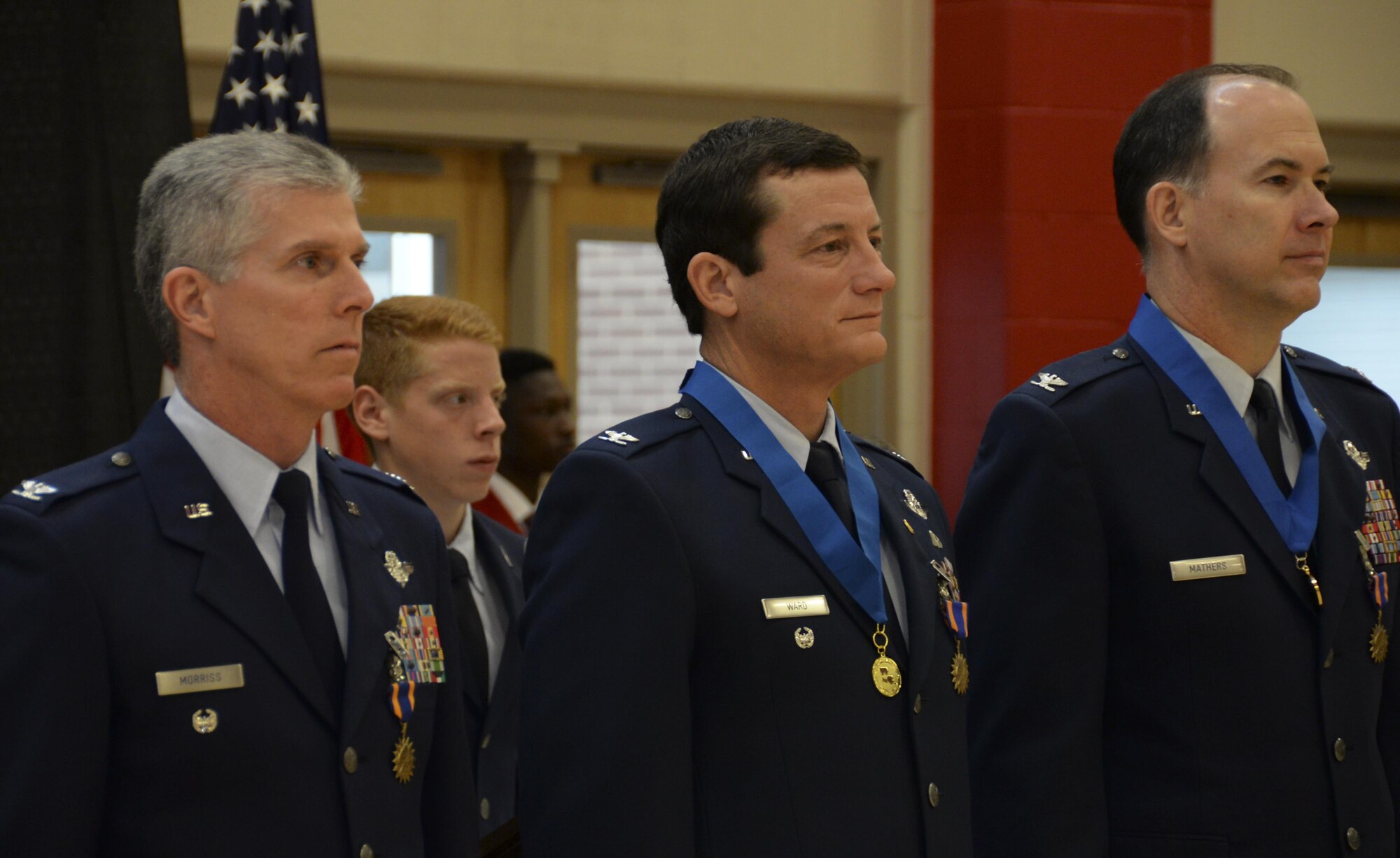 Col. Trey Morriss, retired Col. Russ Mathers and retired Col. Warren Ward, 596th Bomb Squadron Airmen who participated in Operation Senior Surprise, stand proudly after being re-presented with air medals during an annual Veterans Day Tattoo Ceremony at Parkway High School in Bossier City, La., Nov. 11, 2015. Operation Senior Surprise was a clandestine mission that helped kick off Operation Desert Storm. The mission remained classified until Jan 16, 1992, when the crew-members and maintainers who made the mission possible were presented with air, achievement and commendation medals for their efforts. (U.S. Air Force photo/Senior Airman Amanda Morris) 