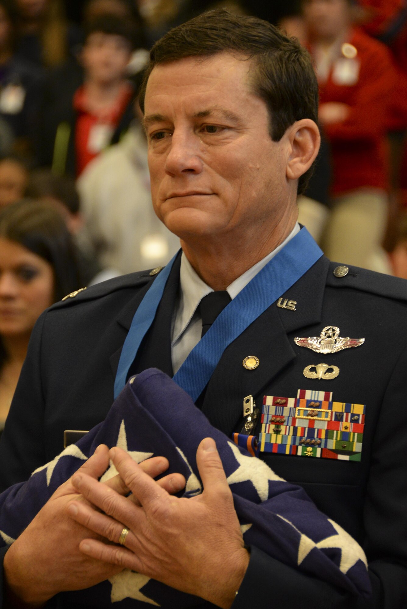 Retired Col. Warren Ward, 596th Bomb Squadron B-52G Stratofortress co-pilot during Operation Senior Surprise, holds an American flag presented by Junior ROTC students during an annual Veterans Day Tattoo Ceremony at Parkway High School in Bossier City, La., Nov. 11, 2015. Operation Senior Surprise was a clandestine mission that helped kick off Operation Desert Storm. JROTC students presented folded flags to Ward, Col. Trey Morriss and retired Col. Russ Mathers, 596th BS Airmen that participated in Operation Senior Surprise, as mementos of the event. (U.S. Air Force photo/Senior Airman Amanda Morris) 