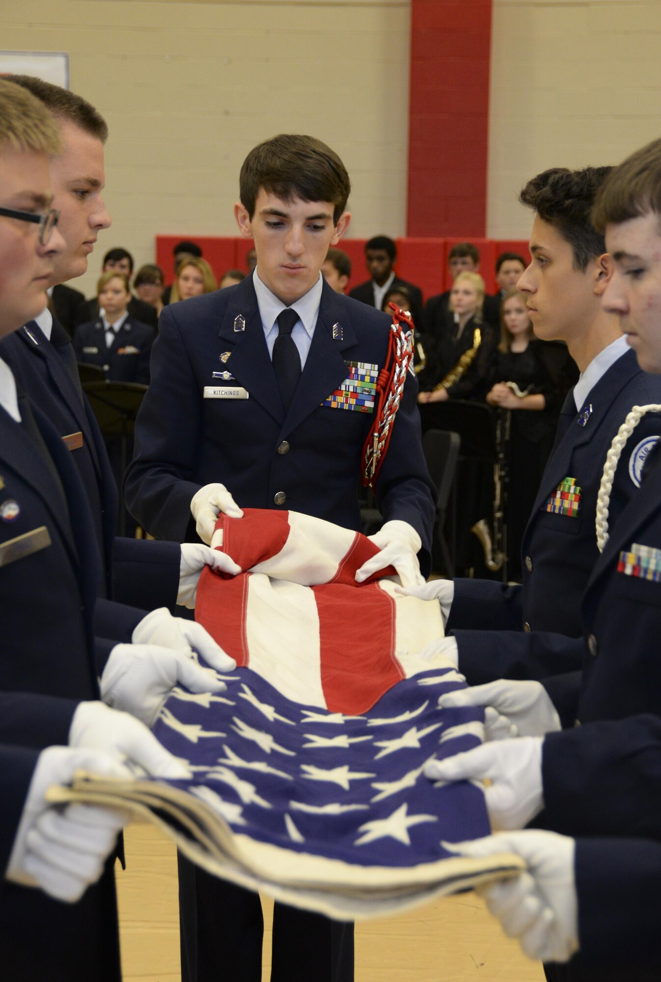 Junior ROTC students perform a flag folding detail during an annual Veterans Day Tattoo Ceremony at Parkway High School in Bossier City, La., Nov. 11, 2015. The students presented folded flags to Col. Trey Morriss, retired Col. Russ Mathers and retired Col. Warren Ward, 596th Bomb Squadron Airmen who participated in Operation Senior Surprise, as mementos of the event. Operation Senior Surprise was a clandestine mission that helped kick off Operation Desert Storm. (U.S. Air Force photo/Senior Airman Amanda Morris) 