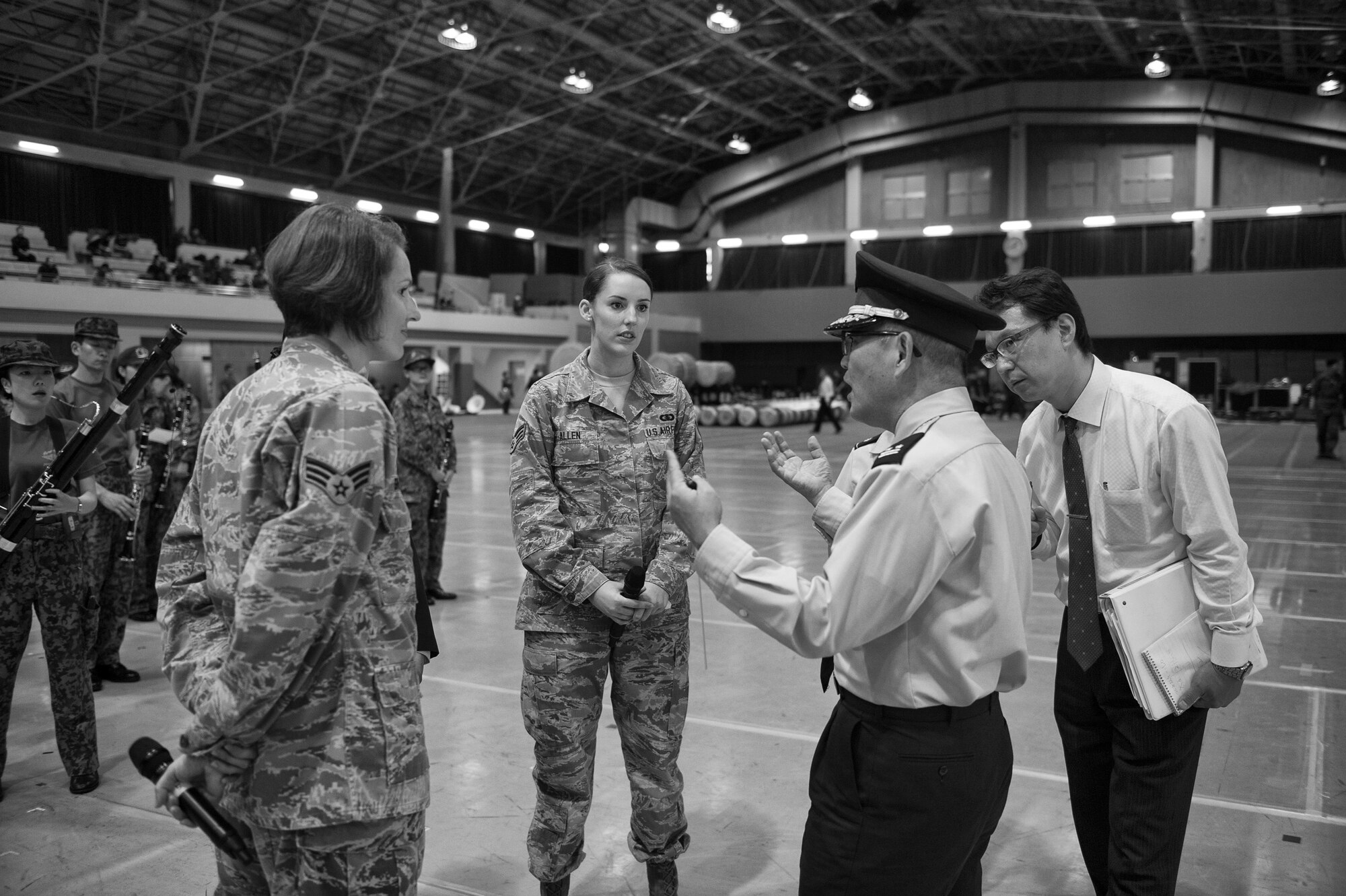 U.S. Air Force Band of the Pacific vocalists Senior Airman Joanne Griffin, left, and Senior Airman Rebecca Allen, center, speak with Japan Air Self-Defense Force Lt. Col. Katsuo Mizushina during a rehearsal at Camp Asaka, Japan, Nov. 10, 2015. The rehearsal gave the band an opportunity to not only refine their performance, but to also engage and interact with Japan Self-Defense Force members. (U.S. Air Force photo/Airman 1st Class Delano Scott)