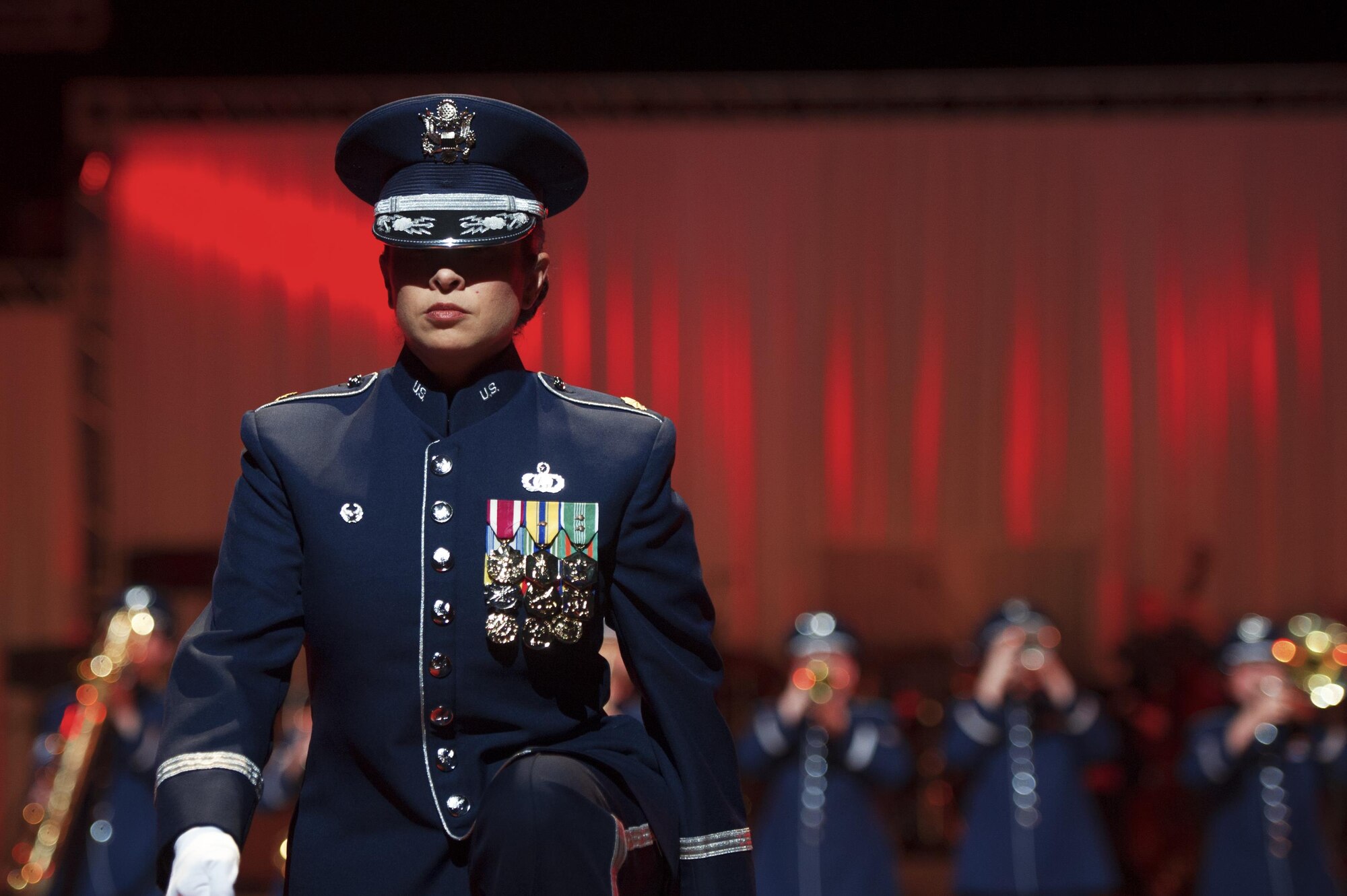 Maj. Cristina Moore Urrutia, the commander and conductor of the U.S. Air Force Band of the Pacific, walks to a podium during the Japan Self-Defense Force Marching Festival at the Nippon Budokan Arena in Tokyo, Japan, Nov. 13, 2015. The three-day festival featured performances from 13 different bands, representing three nations -- the U.S., Japan and South Korea. (U.S. Air Force photo/Airman 1st Class Delano Scott)