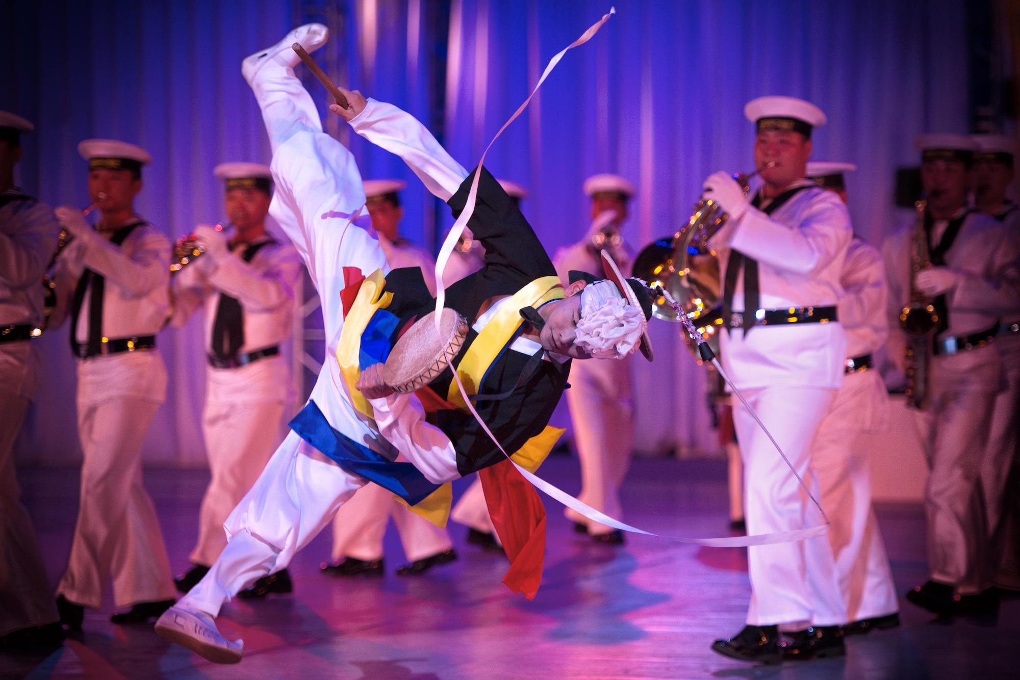 A South Korean navy band performer dances during the Japan Self-Defense Force Marching Festival at the Nippon Budokan Arena in Tokyo, Nov. 13, 2015. The festival allowed all of the bands the opportunity to engage and interact with one another. (U.S. Air Force photo/Airman 1st Class Delano Scott)