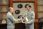 Air Force Lt. Gen. Stanley E. Clarke, III, director, Air National Guard, is presented the Order of the Sword invitation from Chief Master Sgt. James W. Hotaling, command chief master sergeant of the Air National Guard, at 10 House Fire Department, New York, Nov. 11, 2015. The Air Force enlisted corps established the Order of the Sword to recognize and honor military senior officers for significant contributions to the enlisted force. 