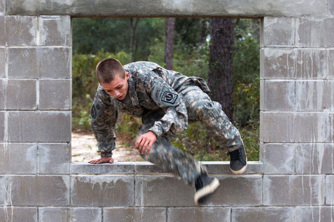 An Army Junior Reserve Officer Training Corps cadet leaps through a window obstacle on Eglin Air Force Base, Fla., Nov. 10, 2015. U.S. Army photo by Pfc. David Stewart