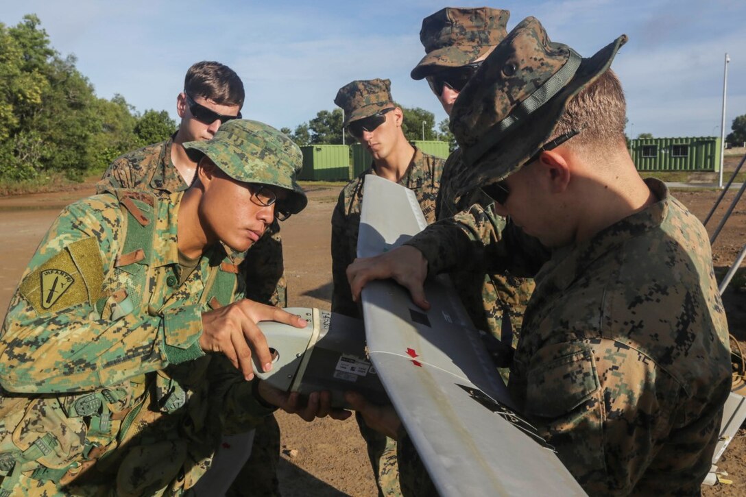 TUTONG, Brunei  (Nov. 11, 2015) U.S. Marines demonstrates the capabilities of the Raven small unmanned aerial vehicle to soldiers from 3rd Battalion, Royal Brunei Land Forces during Combined Afloat Readiness and Training - Brunei 2015.  Elements of the 15th Marine Expeditionary Unit Marines are ashore in Brunei to perform day and night training in an urban environment and to enhance interoperability and partnership between the U.S. and Brunei. The 15th MEU is currently deployed in the Indo-Asia-Pacific region to promote regional stability and security in the U.S. 7th Fleet area of operations. (U.S. Marine Corps photo by Sgt. Jamean Berry/Released)