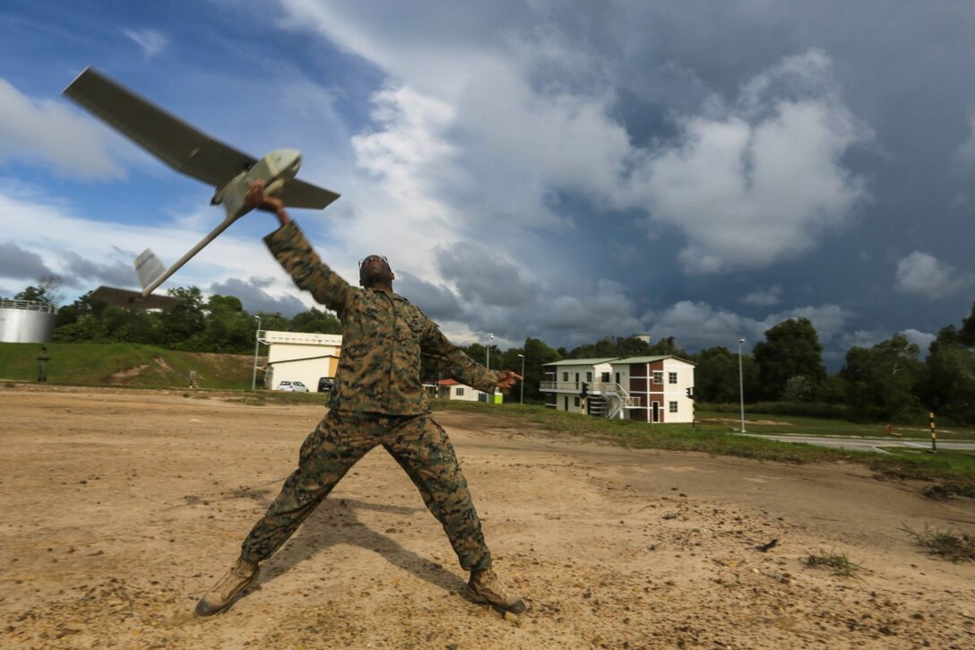 TUTONG, Brunei  (Nov. 10, 2015)  U.S. Marine Cpl. Mark Weatherspoon launches a Raven small unmanned aerial vehicle during Combined Afloat Readiness and Training - Brunei 2015. Weatherspoon is a rifleman with Battalion Landing Team 3rd Battalion, 1st Marine Regiment, 15th Marine Expeditionary Unit. Elements of the 15th MEU Marines are ashore in Brunei to perform day and night training in an urban environment and to enhance interoperability and partnership between the U.S. and Brunei. The 15th MEU is currently deployed in the Indo-Asia-Pacific region to promote regional stability and security in the U.S. 7th Fleet area of operations. (U.S. Marine Corps photo by Sgt. Jamean Berry/Released)