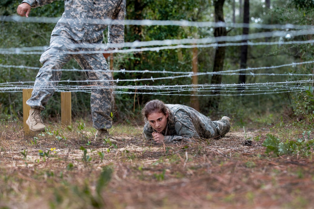 An Army Junior Officer Training Corps cadet crawls under a barbed-wire obstacle on Eglin Air Force Base, Fla., Nov. 10, 2015. U.S. Army photo by Pfc. David Stewart