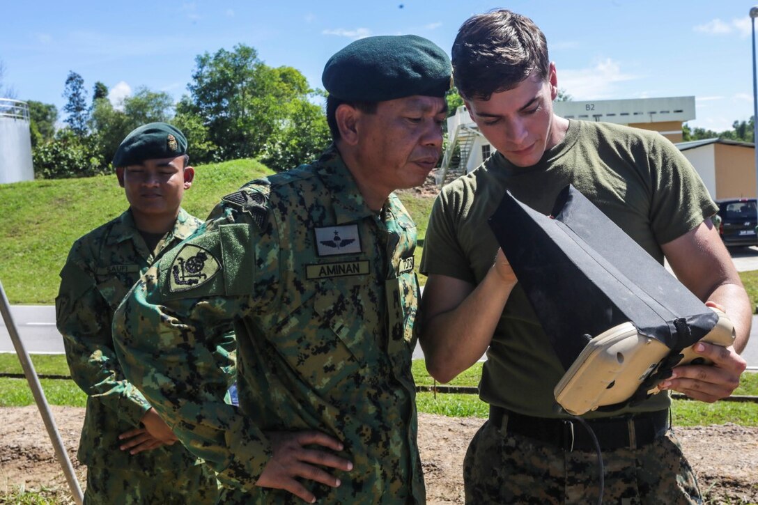 TUTONG, Brunei  (Nov. 11, 2015) U.S. Marine Cpl. Michael Katra, right, shows Brunei Land Force Brig. Gen. Pengiran Dato Seri Pahlawan Aminan Bin Pengiran Haji Mahmud the features of a Raven small aerial unmanned vehicle during Combined Afloat Readiness and Training - Brunei 2015. Katra is an intelligence specialist with Battalion Landing Team 3rd Battalion, 1st Marine Regiment, 15th Marine Expeditionary Unit.  Brig. Gen. Aminan is the Chief of the Army for the Royal Brunei Land Force. Elements of the 15th MEU Marines are ashore in Brunei to perform day and night training in an urban environment and to enhance interoperability and partnership between the U.S. and Brunei. The 15th MEU is currently deployed in the Indo-Asia-Pacific region to promote regional stability and security in the U.S. 7th Fleet area of operations. (U.S. Marine Corps photo by Sgt. Jamean Berry/Released)