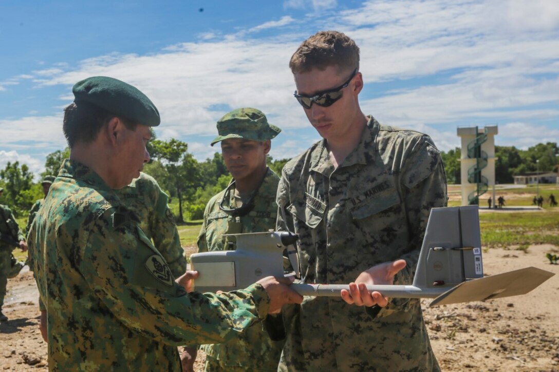 TUTONG, Brunei  (Nov. 11, 2015) U.S. Marine Cpl. Matthew Newman, right, shows Brunei Land Force Brig. Gen. Pengiran Dato Seri Pahlawan Aminan Bin Pengiran Haji Mahmud the main body of a Raven small aerial unmanned vehicle during Combined Afloat Readiness and Training - Brunei 2015.  Newman is a team leader with Battalion Landing Team 3rd Battalion, 1st Marine Regiment, 15th Marine Expeditionary Unit.  Brig. Gen. Aminan is the Chief of the Army for the Royal Brunei Land Force. Elements of the 15th MEU Marines are ashore in Brunei to perform day and night training in an urban environment and to enhance interoperability and partnership between the U.S. and Brunei. The 15th MEU is currently deployed in the Indo-Asia-Pacific region to promote regional stability and security in the U.S. 7th Fleet area of operations. (U.S. Marine Corps photo by Sgt. Jamean Berry/Released)