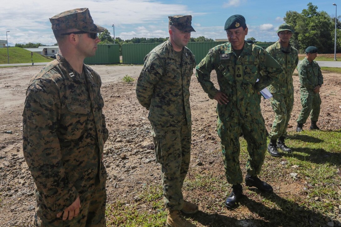 TUTONG, Brunei (Nov. 11, 2015) U.S. Marine Capt. John Garlasco, left, and Capt. Kyle Kurtz, center, discuss training techniques with Royal Brunei Land Force Brig. Gen. Pengiran Dato Seri Pahlawan Aminan Bin Pengiran Haji Mahmud, right, during Combined Afloat Readiness and Training - Brunei 2015. Garlasco is a platoon commander with the 15th Marine Expeditionary Unit’s Force Reconnaissance Detachment. Kurtz is the commanding officer of India Company, Battalion Landing Team 3rd Battalion, 1st Marine Regiment, 15th MEU. Brig. Gen. Aminan is the Chief of the Army for the Royal Brunei Land Forces. Elements of the 15th MEU Marines are ashore in Brunei to perform day and night training in an urban environment and to enhance interoperability and partnership between the U.S. and Brunei. The 15th MEU is currently deployed in the Indo-Asia-Pacific region to promote regional stability and security in the U.S. 7th Fleet area of operations. (U.S. Marine Corps photo by Sgt. Jamean Berry/Released)