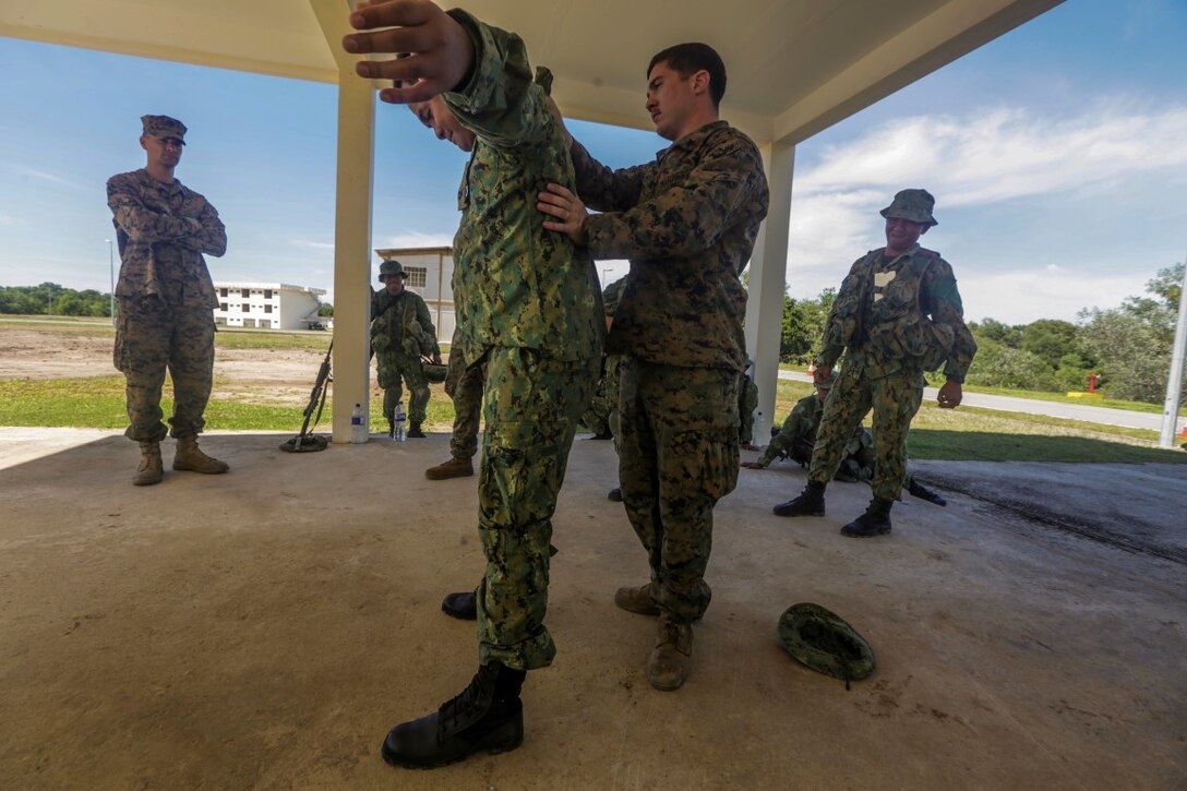 TUTONG, Brunei (Nov. 11, 2015) U.S. Marine Cpl. Timothy Costello instructs U.S. Marines and Soldiers with the Royal Brunei Land Force on search procedures during Combined Afloat Readiness and Training - Brunei 2015. Costello is a military police officer with Combat Logistics Battalion 15, 15th Marine Expeditionary Unit. Elements of the 15th MEU Marines are ashore in Brunei to perform day and night training in an urban environment and to enhance interoperability and partnership between the U.S. and Brunei. The 15th MEU is currently deployed in the Indo-Asia-Pacific region to promote regional stability and security in the U.S. 7th Fleet area of operations. (U.S. Marine Corps photo by Sgt. Jamean Berry/Released)