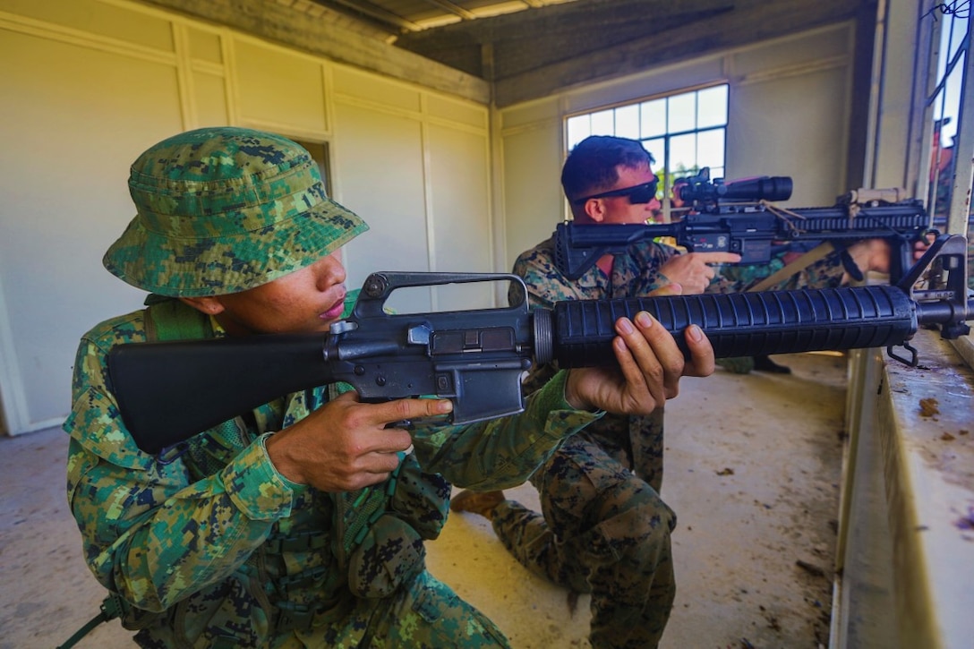 TUTONG, Brunei (Nov. 11, 2015) U.S. Marine Lance Cpl. Jacob Clark and Saidadu Abdullah Mazlan provide security during CARAT-Brunei 2015. Clark is an infantry automatic rifle gunner with Battalion Landing Team 3rd Battalion, 1st Marine Regiment, 15th Marine Expeditionary Unit.  Mazlan is a rifleman with the Royal Brunei Land Force. Elements of the 15th MEU Marines are ashore in Brunei to perform day and night training in an urban environment and to enhance interoperability and partnership between the U.S. and Brunei. The 15th MEU is currently deployed in the Indo-Asia-Pacific region to promote regional stability and security in the U.S. 7th Fleet area of operations. (U.S. Marine Corps HDR photo by Sgt. Jamean Berry/Released)