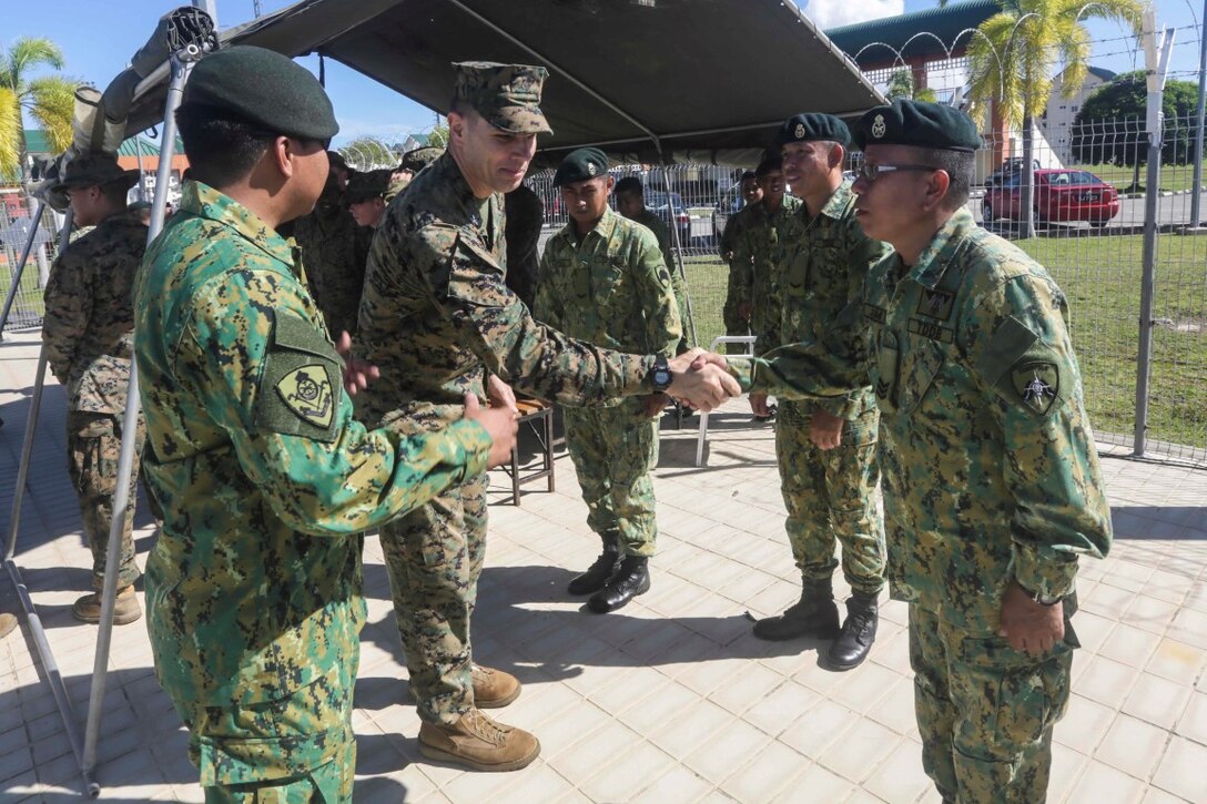 TUTONG, Brunei (Nov. 12, 2015) U.S. Marine Col. Vance L. Cryer shakes hands with officers from 3rd Battalion, Royal Brunei Land Forces following Combined Afloat Readiness and Training - Brunei 2015.  Cryer is the commanding officer of the 15th Marine Expeditionary Unit. Elements of the 15th MEU Marines are ashore in Brunei to perform day and night training in an urban environment and to enhance interoperability and partnership between the U.S. and Brunei. The 15th MEU is currently deployed in the Indo-Asia-Pacific region to promote regional stability and security in the U.S. 7th Fleet area of operations. (U.S. Marine Corps photo by Sgt. Jamean Berry/Released)