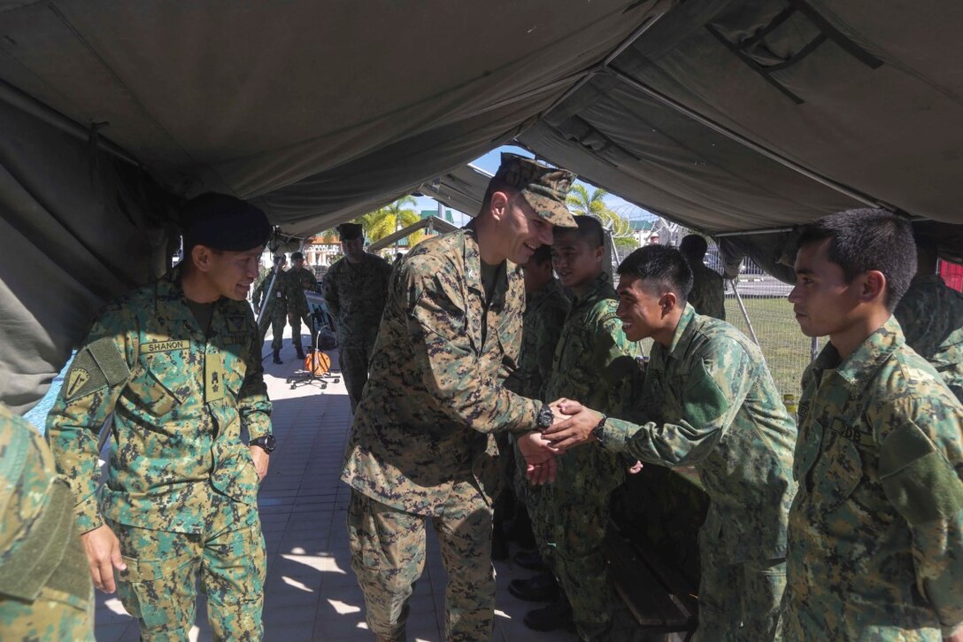 TUTONG, Brunei (Nov. 12, 2015) U.S. Marine Col. Vance L. Cryer shakes hands with officers from 3rd Battalion, Royal Brunei Land Forces following a Combined Afloat Readiness and Training - Brunei 2015.  Cryer is the commanding officer of the 15th Marine Expeditionary Unit. Elements of the 15th MEU Marines are ashore in Brunei to perform day and night training in an urban environment and to enhance interoperability and partnership between the U.S. and Brunei. The 15th MEU is currently deployed in the Indo-Asia-Pacific region to promote regional stability and security in the U.S. 7th Fleet area of operations. (U.S. Marine Corps photo by Sgt. Jamean Berry/Released)