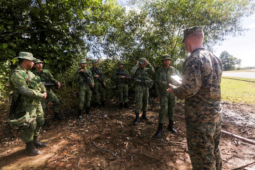 TUTONG, Brunei (Nov. 11, 2015) U.S. Marine Sgt. Bryan Hagan instructs soldiers with the Royal Brunei Land Force on patrolling procedures during Combined Afloat Readiness and Training - Brunei 2015.  Hagan is a squad leader with India Company, Battalion Landing Team 3rd Battalion, 1st Marine Regiment, 15th Marine Expeditionary Unit. Elements of the 15th MEU are ashore in Brunei to perform day and night training in an urban environment and to enhance interoperability and partnership between the U.S. and Brunei. The 15th MEU is currently deployed in the Indo-Asia-Pacific region to promote regional stability and security in the U.S. 7th Fleet area of operations. (U.S. Marine Corps photo by Sgt. Jamean Berry/Released)
