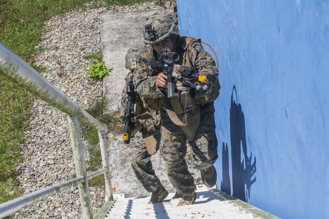TUTONG, Brunei (Nov. 11, 2015)   U.S. Marine Cpl. Lorenzo Sifuentes clears a stairwell during Combined Afloat Readiness and Training - Brunei 2015. Sifuentes is an infantry automatic rifle gunner with India Company, Battalion Landing Team 3rd Battalion, 1st Marine Regiment, 15th Marine Expeditionary Unit.  Elements of the 15th MEU Marines are ashore in Brunei to perform day and night training in an urban environment and to enhance interoperability and partnership between the U.S. and Brunei. The 15th MEU is currently deployed in the Indo-Asia-Pacific region to promote regional stability and security in the U.S. 7th Fleet area of operations. (U.S. Marine Corps photo by Sgt. Jamean Berry/Released)