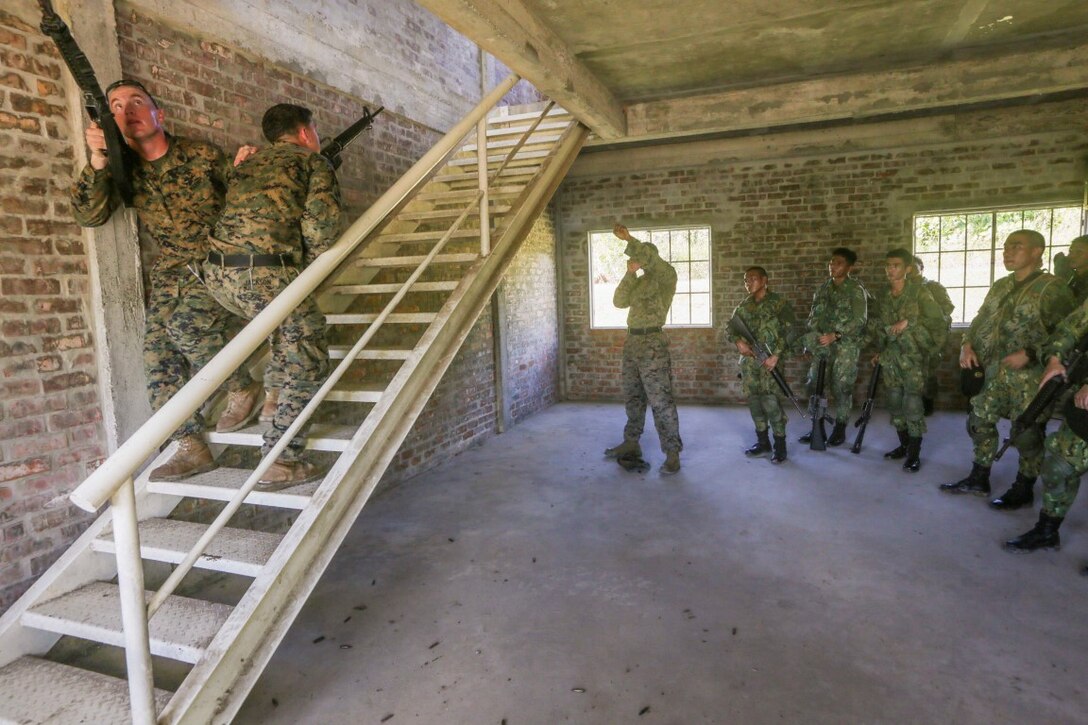 TUTONG, Brunei  (Nov. 11, 2015) U.S. Marine Sgt. Bryan Hagan, left, and Sgt. Ryan Jackson, right, demonstrate stairwell clearing for soldiers with the Royal Brunei Land Force during Combined Afloat Readiness and Training - Brunei 2015.  Hagan and Jackson are squad leaders with India Company, Battalion Landing Team 3rd Battalion, 1st Marine Regiment, 15th Marine Expeditionary Unit. Elements of the 15th MEU Marines are ashore in Brunei to perform day and night training in an urban environment and to enhance interoperability and partnership between the U.S. and Brunei. The 15th MEU is currently deployed in the Indo-Asia-Pacific region to promote regional stability and security in the U.S. 7th Fleet area of operations. (U.S. Marine Corps photo by Sgt. Jamean Berry/Released)
