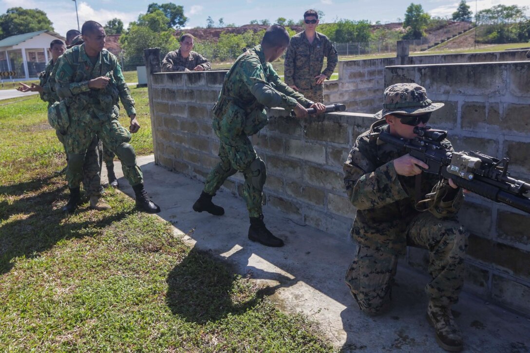 TUTONG, Brunei (Nov. 11, 2015) U.S. Marines with the 15th Marine Expeditionary Unit and soldiers with the Royal Brunei Land Force practice breaching techniques during Combined Afloat Readiness and Training -  Brunei 2015. Elements of the 15th MEU Marines are ashore in Brunei to perform day and night training in an urban environment and to enhance interoperability and partnership between the U.S. and Brunei. The 15th MEU is currently deployed in the Indo-Asia-Pacific region to promote regional stability and security in the U.S. 7th Fleet area of operations. (U.S. Marine Corps photo by Sgt. Jamean Berry/Released)
