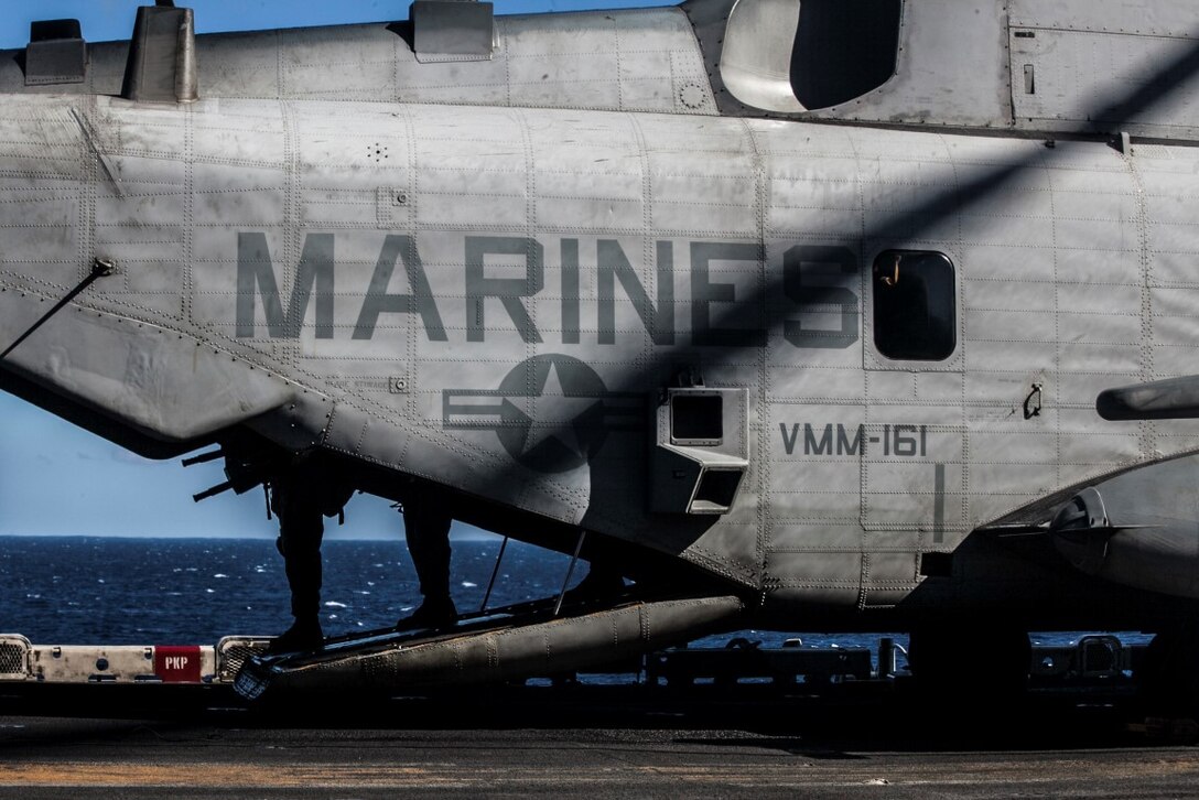 SOUTH CHINA SEA (Nov. 16, 2015) U.S. Sailors and Marines with Combat Logistics Battalion 15, 15th Marine Expeditionary Unit, begin to debark an MV-22B Osprey during a mass-casualty drill on the flight deck of the USS Essex (LHD 2). The Marines and Sailors honed their skills to become quicker and more efficient should a situation arise where medical attention is needed. The 15th MEU is currently deployed in the Indo-Asia-Pacific region to promote regional stability and security in the U.S. 7th Fleet area of operations. (U.S. Marine Corps photo by Cpl. Elize McKelvey/Released)