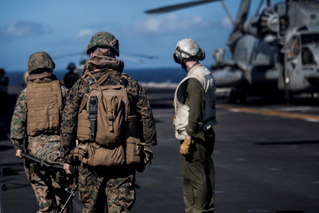 SOUTH CHINA SEA (Nov. 16, 2015) U.S. Sailors and Marines with Combat Logistics Battalion 15, 15th Marine Expeditionary Unit, transport simulated causalities during a mass-casualty drill on the flight deck of the USS Essex (LHD 2). The Marines and Sailors honed their skills to become quicker and more efficient should a situation arise where medical attention is needed. The 15th MEU is currently deployed in the Indo-Asia-Pacific region to promote regional stability and security in the U.S. 7th Fleet area of operations. (U.S. Marine Corps photo by Cpl. Elize McKelvey/Released)