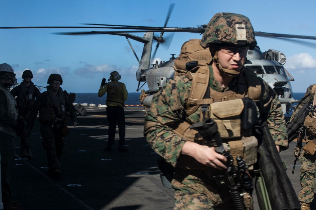 SOUTH CHINA SEA (Nov. 16, 2015) U.S. Sailors and Marines with Combat Logistics Battalion 15, 15th Marine Expeditionary Unit, run to simulated causalities during a mass-casualty drill on the flight deck of the USS Essex (LHD 2). The Marines and Sailors honed their skills to become quicker and more efficient should a situation arise where medical attention is needed. The 15th MEU is currently deployed in the Indo-Asia-Pacific region to promote regional stability and security in the U.S. 7th Fleet area of operations. (U.S. Marine Corps photo by Cpl. Elize McKelvey/Released)