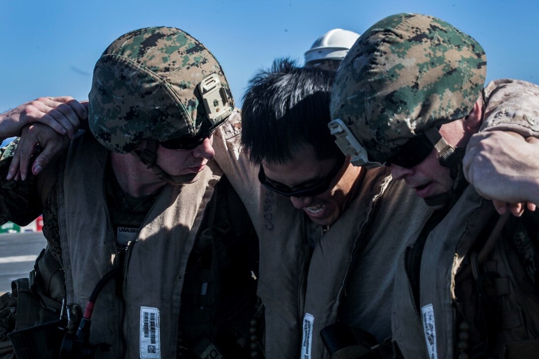 SOUTH CHINA SEA (Nov. 16, 2015) U.S. Marines and Sailors with Combat Logistics Battalion 15, 15th Marine Expeditionary Unit, transport a simulated causality during a mass-casualty drill on the flight deck of the USS Essex (LHD 2). The Marines and Sailors honed their skills to become quicker and more efficient should a situation arise where medical attention is needed. The 15th MEU is currently deployed in the Indo-Asia-Pacific region to promote regional stability and security in the U.S. 7th Fleet area of operations. (U.S. Marine Corps photo by Cpl. Elize McKelvey/Released)
