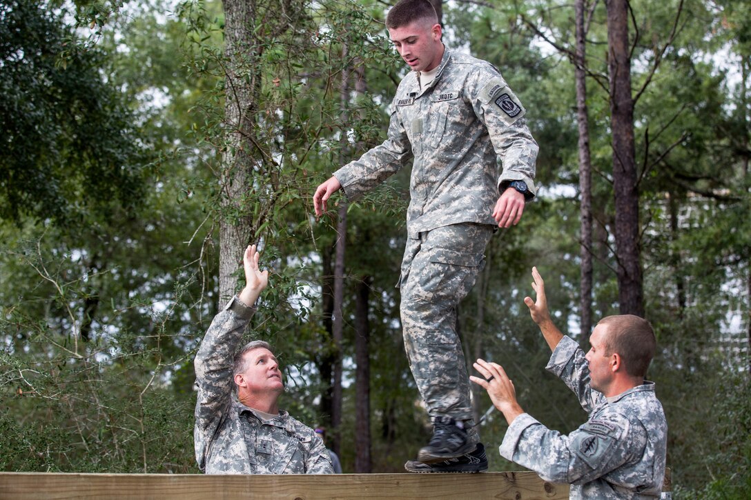 An Army Junior Officer Training Corps cadet crosses a balance beam on Eglin Air Force Base, Fla., Nov. 10, 2015. U.S. Army photo by Pfc. David Stewart