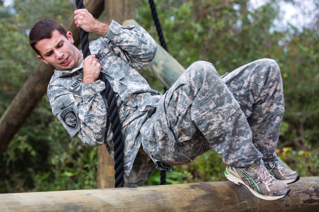 An Army Junior Officer Training Corps cadet uses a rope to swing over a log while navigating an obstacle course on Eglin Air Force Base, Fla., Nov. 10, 2015. U.S. Army photo by Pfc. David Stewart

