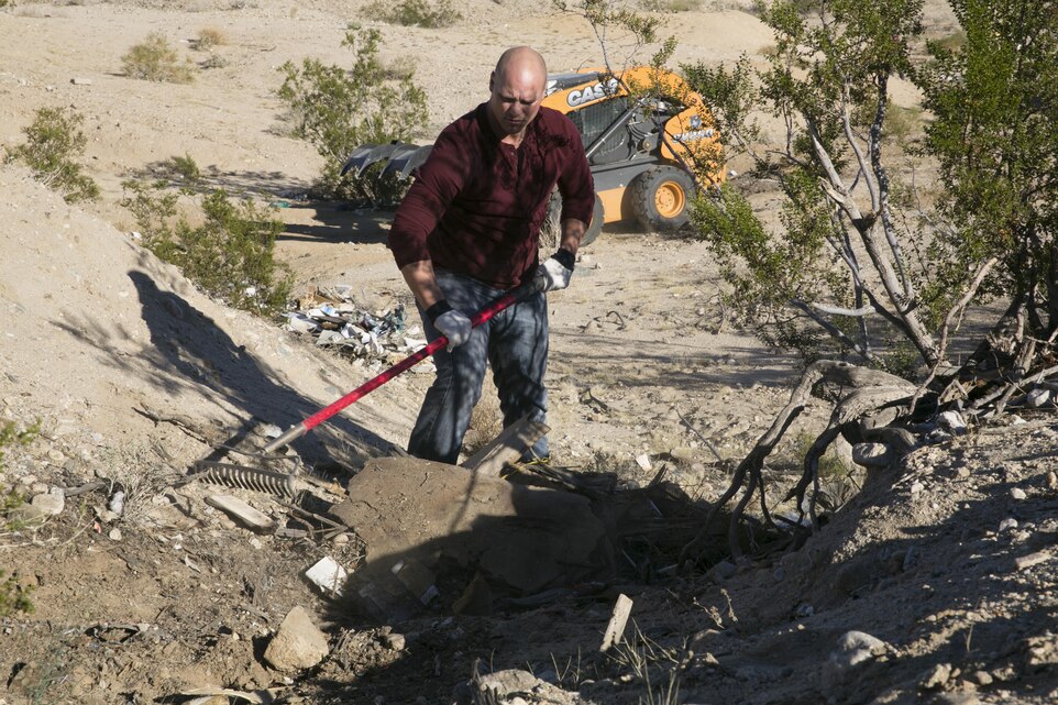 Cpl. Roman Riddle, tank gunner, 1st Tank Battalion, collects trash during a community cleanup event in Twentynine Palms, Calif., Nov. 6, 2015. (Official Marine Corps photo by Lance Cpl. Thomas Mudd/Released)