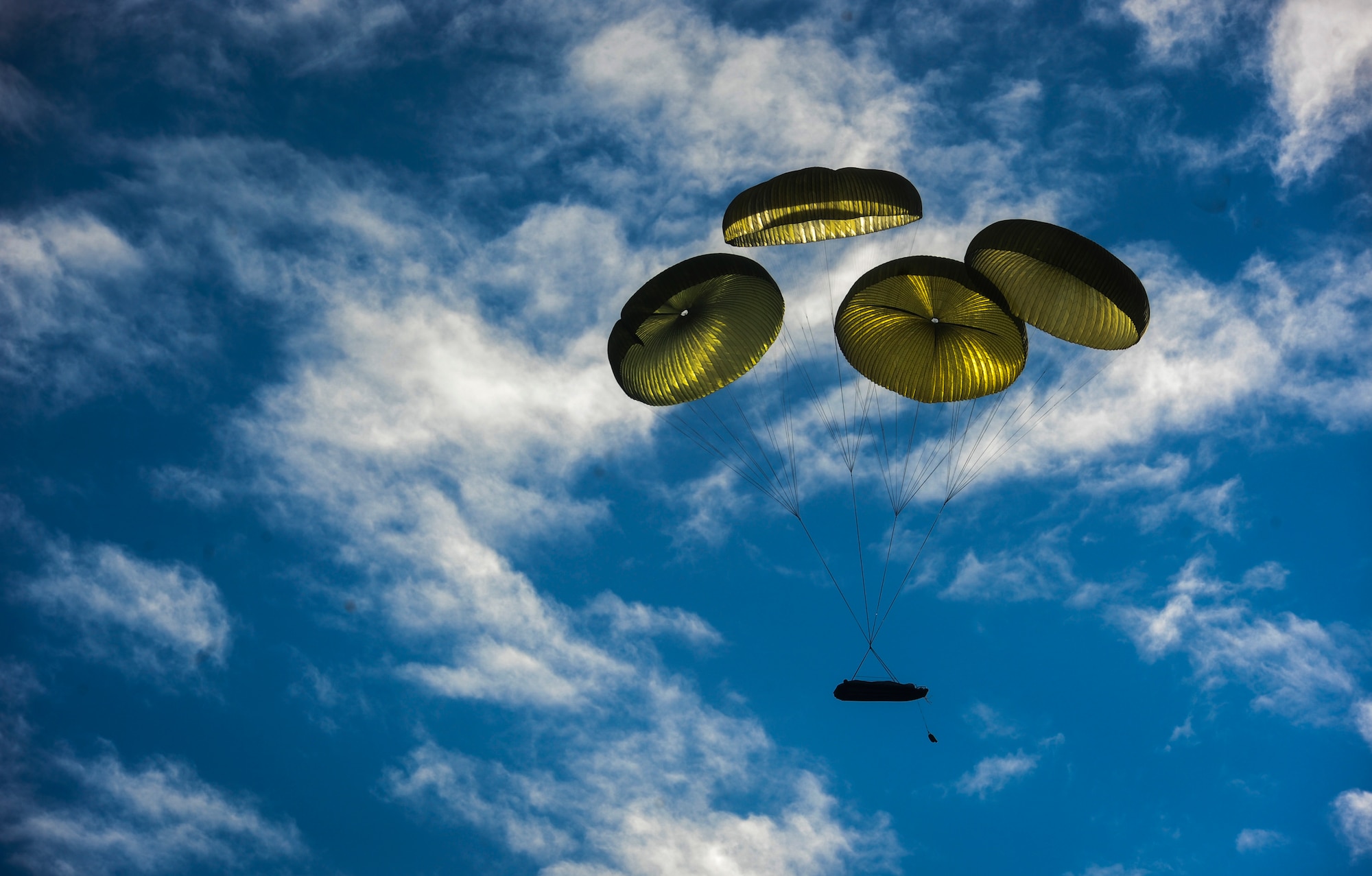 A rigid inflatable boat descends into the Gulf of Mexico after being deployed from an MC-130H Combat Talon II during Maritime Craft Aerial Delivery Systems (MCADS) training, Nov. 12, 2015. MCADS enable special operation forces members to rapidly deploy anywhere around the world in a maritime environment. (U.S. Air Force photo by Senior Airman Meagan Schutter)