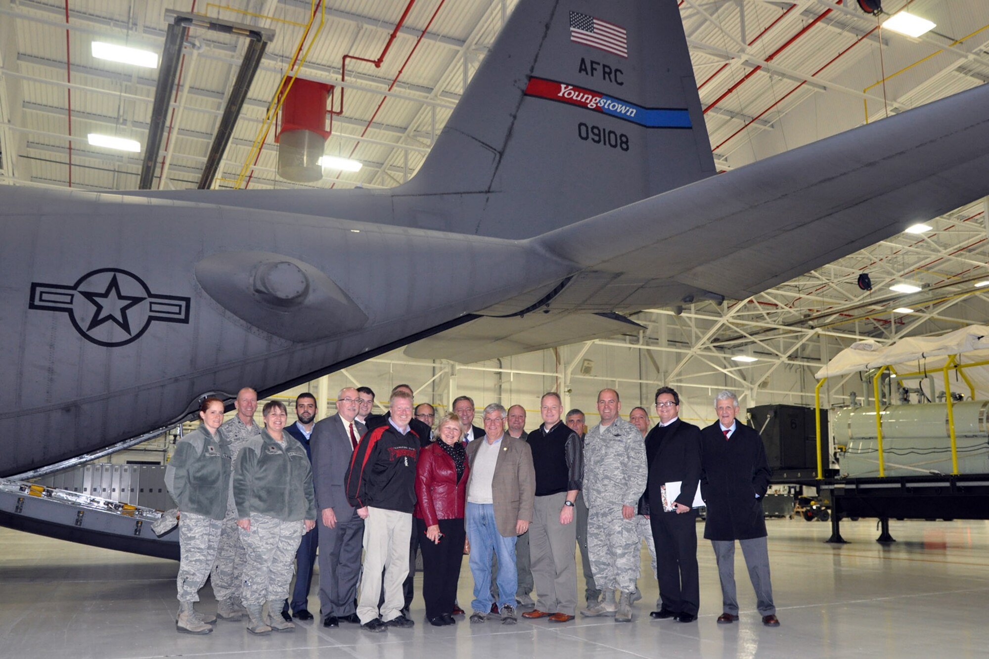 A group of Distinguished Visitors (DVs) stand in front of a 910th Airlift Wing C-130 Hercules tactical cargo transport aircraft during a tour stop here, Nov. 13, 2015.  The group, joined in the photo by members of the 910th, was participating in a tour of various sites across the Mahoning Valley sponsored by YSU President James Tressel. YARS was included in the tour because of its role as the only military base in Northeast Ohio as well as being home to the 910th Airlift Wing and the Department of Defense’s only large-area, fixed wing aerial spray capability. (U.S. Air Force photo/Master Sgt. Bob Barko Jr.) 