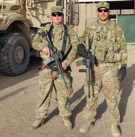 Staff Sgt. Patrick Henry (right) and Sgt. David Ficks, 663rd Engineering Company, pose for a photo at an Afghan National Army base in 2014 where they were training the ANA soldiers on heavy equipment operation and engineering projects. Henry is a Wounded Warrior assigned to the U.S. Army Engineering and Support Center, Huntsville’s Internal Review Office.