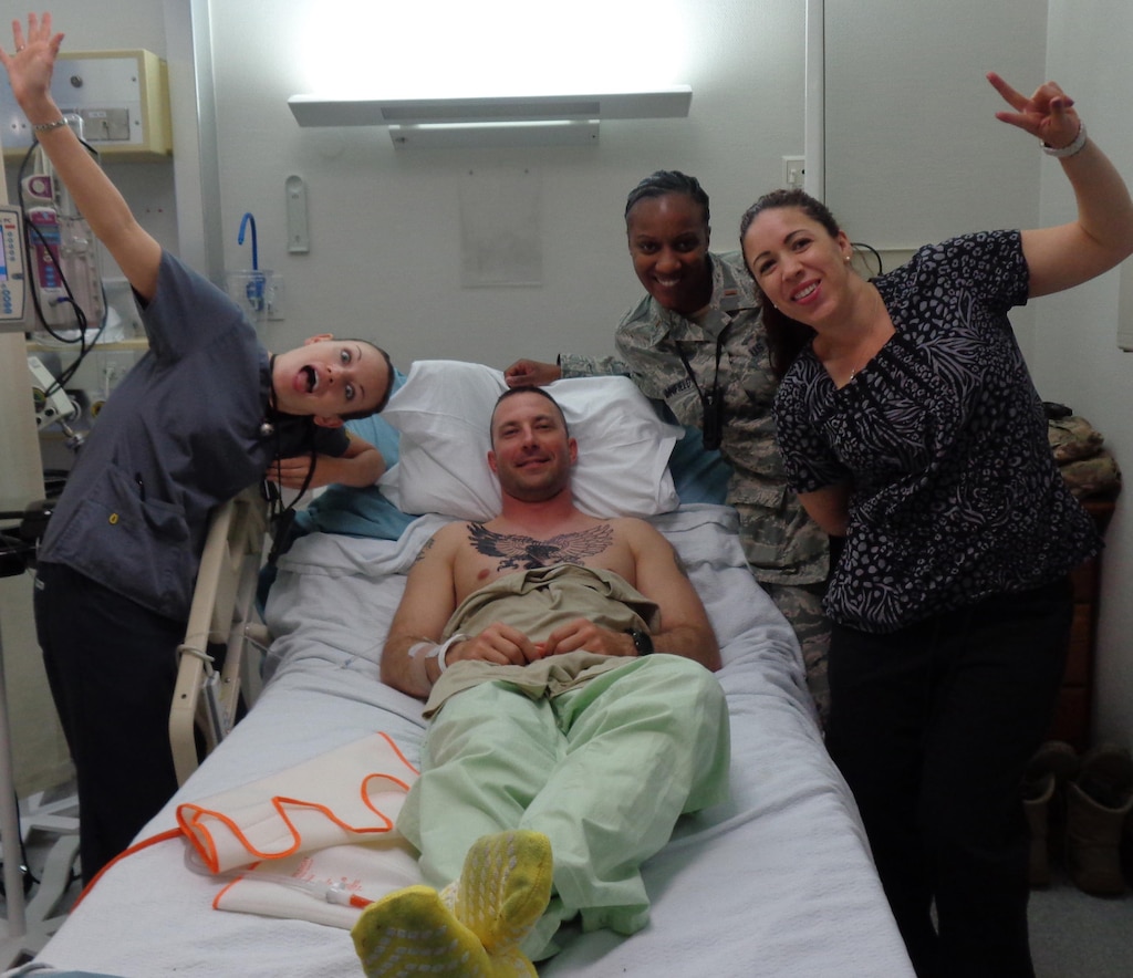 Staff Sgt. Patrick Henry with his nurses at Landstuhl Regional Medical Center, Germany, after spine surgery in July 2014 to remove a piece of the fragmented disk lodged between his vertebra and nerve.  Henry is a Wounded Warrior assigned to the U.S. Army Engineering and Support Center, Huntsville’s Internal Review Office.