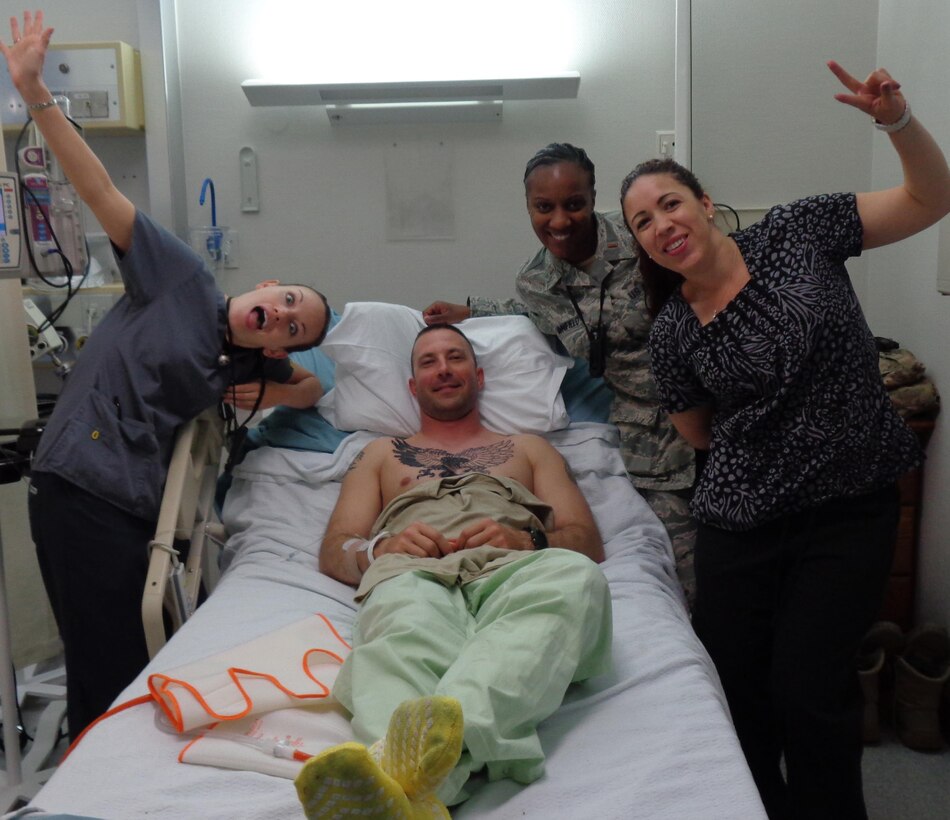 Staff Sgt. Patrick Henry with his nurses at Landstuhl Regional Medical Center, Germany, after spine surgery in July 2014 to remove a piece of the fragmented disk lodged between his vertebra and nerve.  Henry is a Wounded Warrior assigned to the U.S. Army Engineering and Support Center, Huntsville’s Internal Review Office.