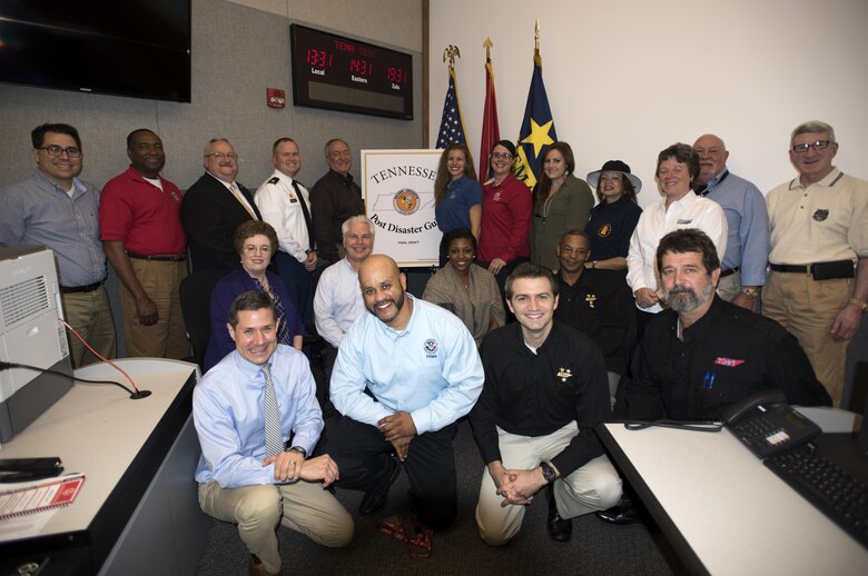 Silver Jackets partners pose together Nov. 17, 2015 during a ceremony at the Tennessee Emergency Management Agency to announce the distribution of the Tennessee Post Disaster Guide to emergency management personnel across the state.  Silver Jackets is an innovative program where multiple state, federal, and sometimes tribal and local agencies learn from each other and apply knowledge to reduce risk to natural hazards.  Program goals include improved communication, facilitation of actions to reduce vulnerability and consequences of flooding, creation or supplement of mechanisms to implement or recommend solutions, leverage of available resources, and development of comprehensive regional flood risk management strategies.
