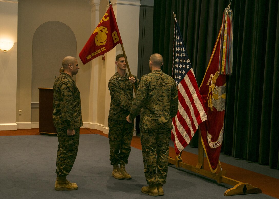 Capt. James Prussing, the outgoing commanding officer of Bravo Company, Marine Barracks Washington, D.C., relinquishes command to Capt. David Moon during a change of command ceremony at the Barracks, Nov. 18, 2015. Moon was a platoon commander for third platoon in Bravo Company before assuming command of the company. (U.S. Marine Corps photo by Cpl. Skye Davis)