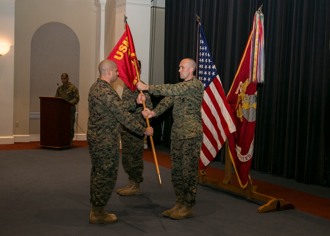 Capt. David Moon, Bravo Company Commander, returns Company B’s guidon to Company First Sergeant Julian Lumm during a change of command ceremony for the company at Marine Barracks Washington, D.C., Nov. 18, 2015. Company B is one of two ceremonial marching units at the Barracks and is home to the Body Bearers. (U.S. Marine Corps photo by Cpl. Skye Davis/Released)