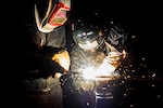 WATERS SOUTH OF JAPAN (Nov. 18, 2015) Hull Technician Fireman Leahmond Tyre, left, from Philadelphia, and Hull Technician Fireman Monica Huerta, from Tucson, Ariz., weld a brace bar using a stick welder aboard the U.S. Navy's only forward-deployed aircraft carrier USS Ronald Reagan (CVN 76). Ronald Reagan and its embarked air wing, Carrier Air Wing (CVW) 5, provide a combat-ready force that protects and defends the collective maritime interests of the U.S. and its allies and partners in the Indo-Asia-Pacific region. 
