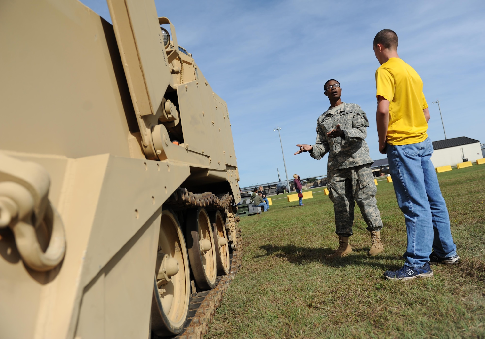 Army Private Denzel Blakely, 287th Engineering Mobility Augmentation Company combat engineer, Army National Guard, Lucedale, Miss., discusses the use of armored combat engineer vehicles with Cadet Douglas Dickerson, St. Martin High School Air Force Junior ROTC, Ocean Springs, Miss., during the second annual Mississippi All-Services Junior ROTC Drill Competition Nov. 14, 2015, at Keesler Air Force Base, Miss. Recruiting booths and static displays, including military vehicles, equipment and an aircraft were available to the cadets throughout the competition. (U.S. Air Force photo by Kemberly Groue)