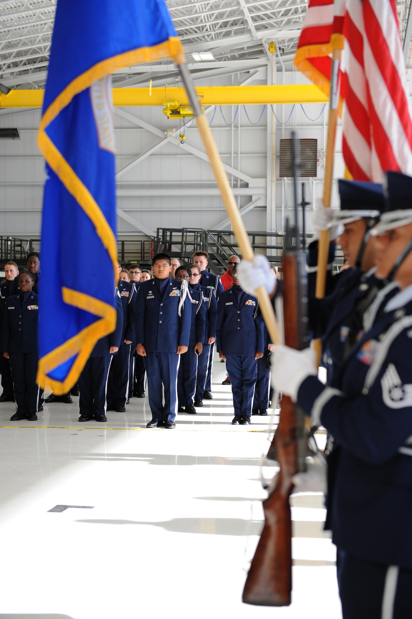 Air Force Junior ROTC cadets from Biloxi High School, Biloxi, Miss., stand at attention during the presentation of colors at the second annual Mississippi All-Services Junior ROTC Drill Competition Nov. 14, 2015, at Keesler Air Force Base, Miss. Seventeen Junior ROTC teams from all military branches were represented at the event. Approximately 800 Junior ROTC cadets and spectators were in attendance where cadets battled for the best all-services Junior ROTC team for Mississippi. Recruiting booths and static displays, including military vehicles, equipment and an aircraft were available to the cadets throughout the competition. (U.S. Air Force photo by Kemberly Groue)