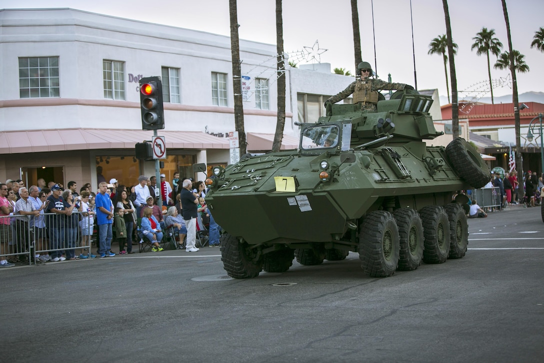 Marines with 3rd Light Armored Reconnaissance Battalion steadily drive down the road in a Light Armored Vehicle during the annual Palm Springs Veterans Day Parade in Palm Springs, Calif., Nov. 11, 2015. (Official Marine Corps photo by Lance Cpl. Levi Schultz/Released)