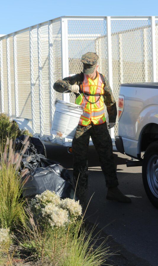 A Marine stationed aboard Marine Corps Air Station Miramar, Calif., loads trash into a truck during a base-wide cleanup on MCAS Miramar, Nov. 16. Marines picked up trash, pulled weeds and cut the grass aboard the station and outside the gate.(U.S. Marine Corps photo by Lance Cpl. Kimberlyn Adams/Released)