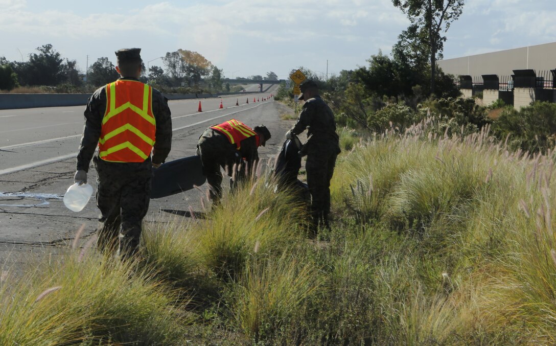 Marines stationed aboard Marine Corps Air Station Miramar, Calif., collect and remove garbage along Kearny Villa Road during a base-wide cleanup on and around MCAS Miramar, Nov. 16. Marines picked up trash, pulled weeds and cut the grass aboard the station and outside the gate.(U.S. Marine Corps photo by Lance Cpl. Kimberlyn Adams/Released)