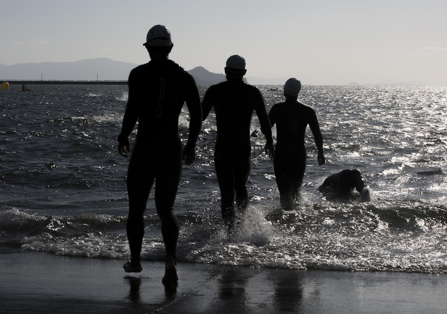 Swimmers dive in for their second lap at the harbor during the 28th Annual Triathlon at Marine Corps Air Station Iwakuni, Japan, Oct. 25, 2015. Approximately 100 station residents and Japanese athletes endured the demanding course, finishing with a rowdy crowd cheering them across the finish line.