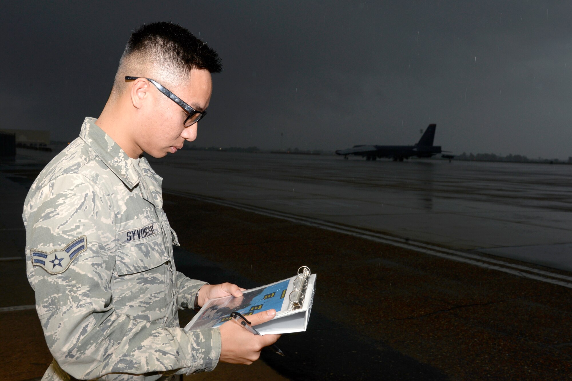 Airman 1st Class Alex Syvongsay, 2nd Operations Support Squadron weather apprentice, conducts a visibility check during inclement weather at Barksdale Air Force Base, La., Nov. 17, 2015. Weather technicians responsibilities include briefing aircrew on weather conditions and supporting Barksdale's mission of getting B-52 Stratofortress bombers in the air by providing weather updates in real time. (U.S. Air Force photo/Tech. Sgt. Marie Brown)