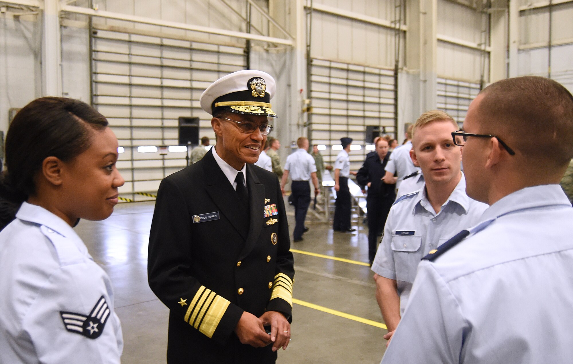 U.S. Navy Adm. Cecil D. Haney, U.S. Strategic Command commander,  speaks with Senior Airman Allyson Martin (left), Airman 1st Class Derek Taylor (center right) and 2nd Lt. Matthew Stark (right) of the 90th Contracting Squadron following a change of command ceremony for the 20th Air Force and Task Force 214 at F.E. Warren Air Force Base, Wyo., Nov. 16, 2015. During the ceremony, Maj. Gen. Anthony J. Cotton assumed command of the two units. TF 214 falls under USSTRATCOM, while the 20th Air Force is part of Air Force Global Strike Command. TF 214 provides the President of the United States with responsive and highly reliable strategic missile forces, and supports USSTRATCOM's strategic deterrence mission by operating and maintaining the Air Force's Intercontinental Ballistic Missile force. One of nine DoD unified combatant commands, USSTRATCOM has global strategic missions, assigned through the Unified Command Plan, which also include space operations; cyberspace operations; joint electronic warfare; global strike; missile defense; intelligence, surveillance and reconnaissance; combating weapons of mass destruction; and analysis and targeting. (U.S. Air Force photo by R.J. Oriez)