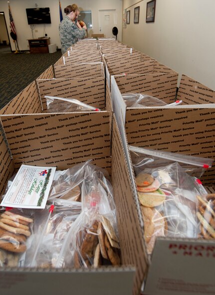 Volunteers from Team Vance prepare care packages Nov. 17 at the Community Chapel Activities Center at Vance Air Force Base, Okla. There were 22 boxes filled with assorted cookies and holiday greeting cards for deployed members from Vance. (U.S. Air Force photo / Staff Sgt. Nancy Falcon)