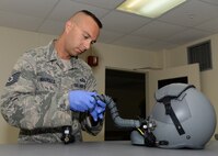 Tech. Sgt. Brian Misuraca, 36th Wing Advanced Programs Office security manager, inspects an aircrew flight helmet Nov. 17, 2015, at Andersen Air Force Base, Guam. Misuraca who was recently recognized as a winner of the 40 Under 40 military class of 2015, is responsible for taking care of flight equipment for deployers as well as temporary duty personnel  (U.S. Air Force photo by Senior Airman Cierra Presentado/Released)